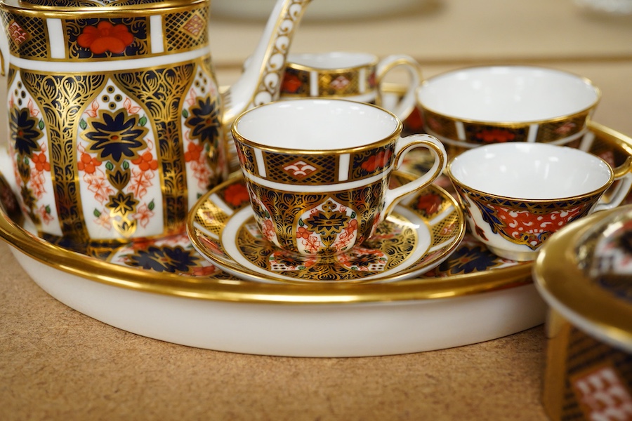 A small collection of Royal Crown Derby miniature tea for two and a pill box, tray 19cm wide. Saucer missing on tea for two.